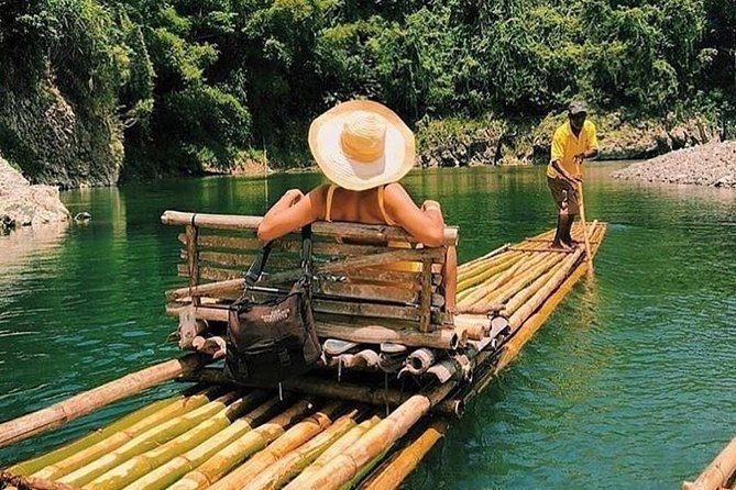 Authentic Jamaican Bamboo Rafting Tour from Montego Bay - Getting on the Martha Brae bamboo raft: teamwork with a captain keeping it safe