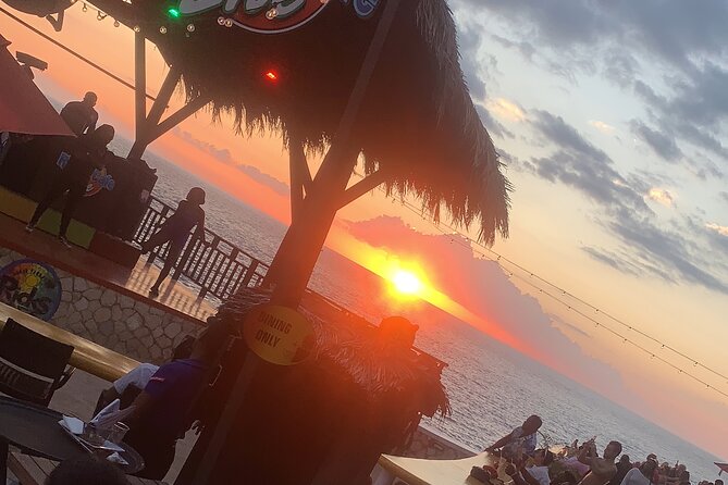 Combo tour ATV + bamboo river rafting from Montego Bay - Rick’s Cafe at sunset: views, music, and the cliff-jump option