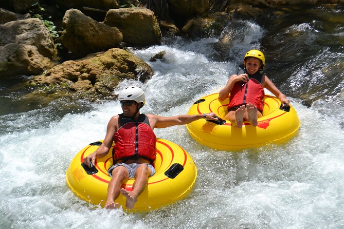 Falmouth Waterfalls River Tubing and Beach Adventure - Rio Bueno tubing: rapids, jungle views, and a guide steering the fun