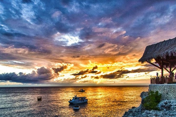 Jamaica Sunset at Rick's Cafe Private Tour with Transfer - Ricks Cafe at sunset: reggae, DJ energy, and cliff-jumping shows